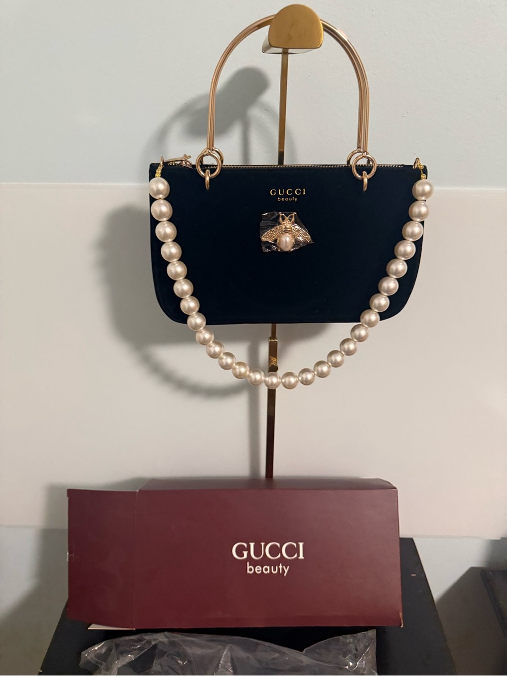 Gucci Beauty Velvet Black cosmetic pouch with gold tone handles and a pearl drop